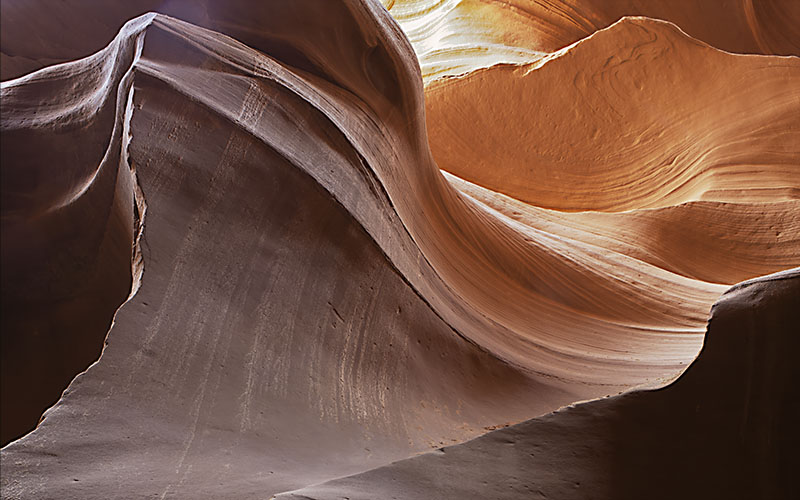 Sinuous warm sandstone walls of Antelope Canyon with dramatic light